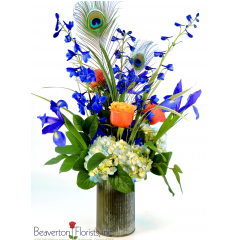 Beaverton Florists Beaverton - A symphony of blue blooms, this design is sure to please. Featuring blue delphinium, iris, hydrangea and cherry brandy roses.

***VASE MAY VARY.