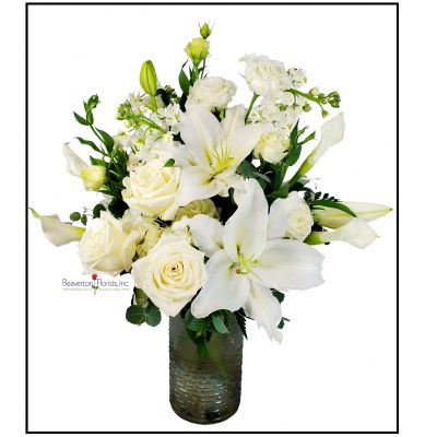 Beaverton Florists Beaverton - Magnificent White arrangement.
Luxurious roses, lilies, hydrangea, calla lilies and soft greens. 
Decorative glass vase.