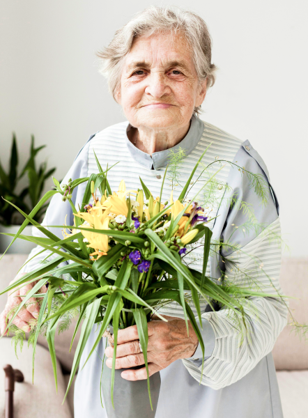 Elderly Lady Holding Plant