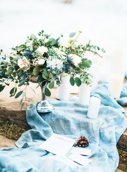 Flowers and Candle on Blue Blanket